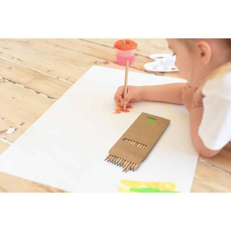 Little blonde girl painting on big white paper while laying on the floor indoors.